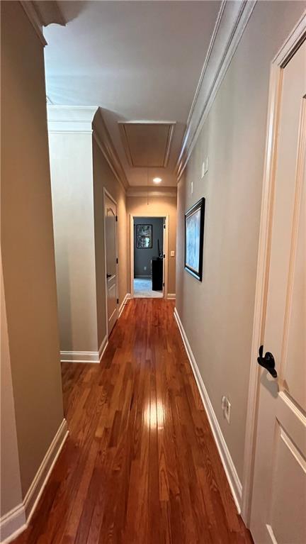 1175 Grassy Oat Ln, Lawrenceville, GA 30045 - hallway featuring attic access, wood finished floors, and crown molding