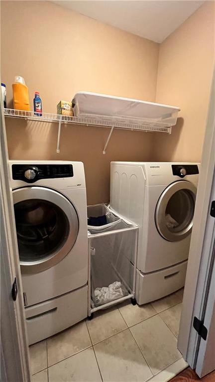 1175 Grassy Oat Ln, Lawrenceville, GA 30045 - laundry room featuring washer and clothes dryer and light tile patterned floors