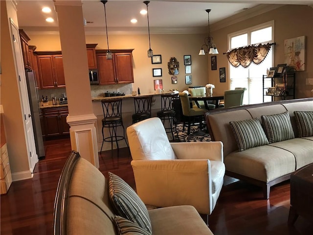 1175 Grassy Oat Ln, Lawrenceville, GA 30045 - living area featuring decorative columns, ornamental molding, dark wood-type flooring, and recessed lighting