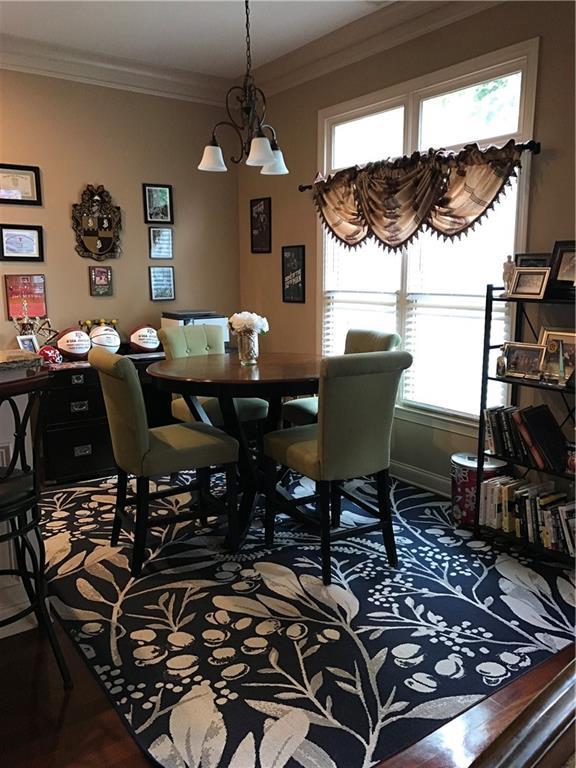 1175 Grassy Oat Ln, Lawrenceville, GA 30045 - dining room featuring crown molding, plenty of natural light, and a chandelier