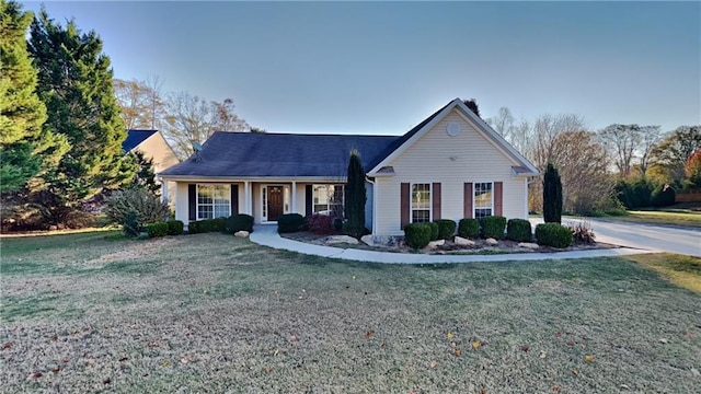 view of front of house featuring covered porch and a front yard