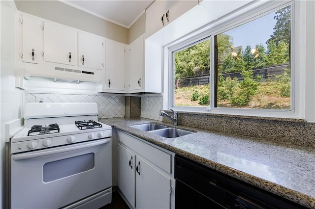 kitchen featuring black dishwasher, backsplash, white gas stove, white cabinets, and sink