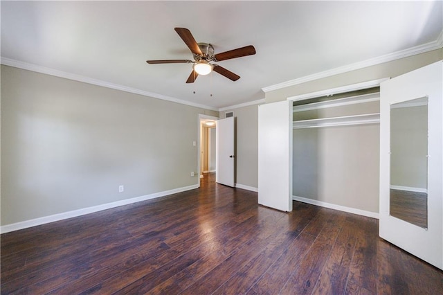 unfurnished bedroom featuring ceiling fan, a closet, dark hardwood / wood-style floors, and crown molding