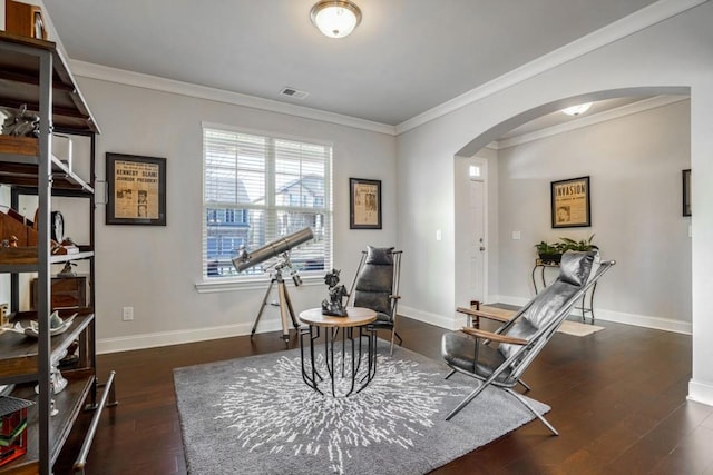 living area featuring dark wood-type flooring and ornamental molding