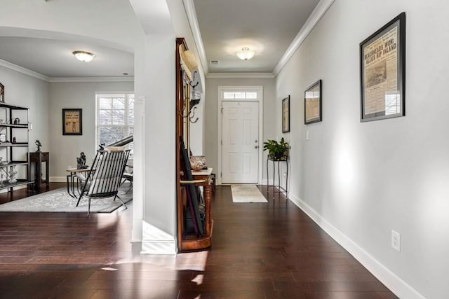 foyer entrance featuring ornamental molding and dark wood-type flooring