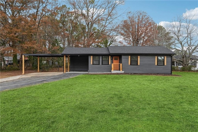 view of front facade with a carport and a front yard