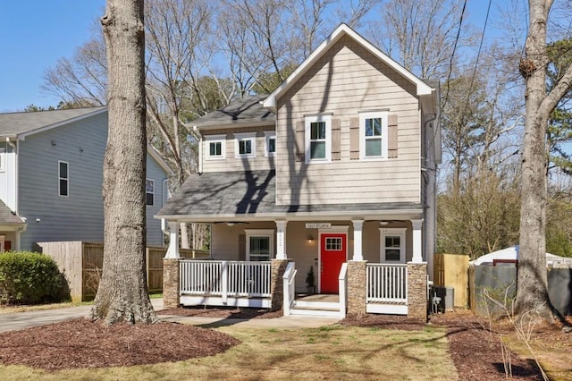 view of front of home with a porch and fence