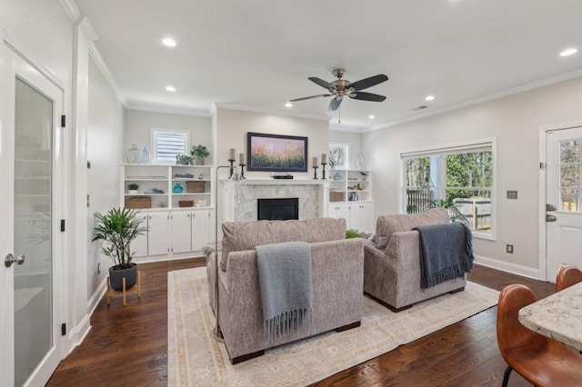 living room with recessed lighting, baseboards, dark wood-type flooring, and a fireplace