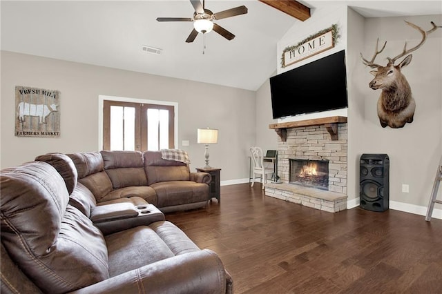 living room featuring a stone fireplace, high vaulted ceiling, beamed ceiling, dark hardwood / wood-style flooring, and ceiling fan