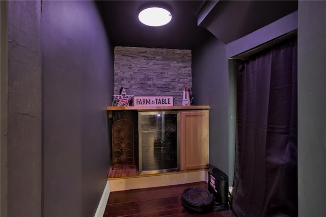 interior space with wood-type flooring and beverage cooler