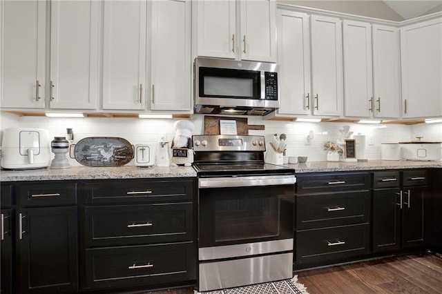 kitchen with stainless steel appliances, dark hardwood / wood-style floors, tasteful backsplash, light stone countertops, and white cabinets