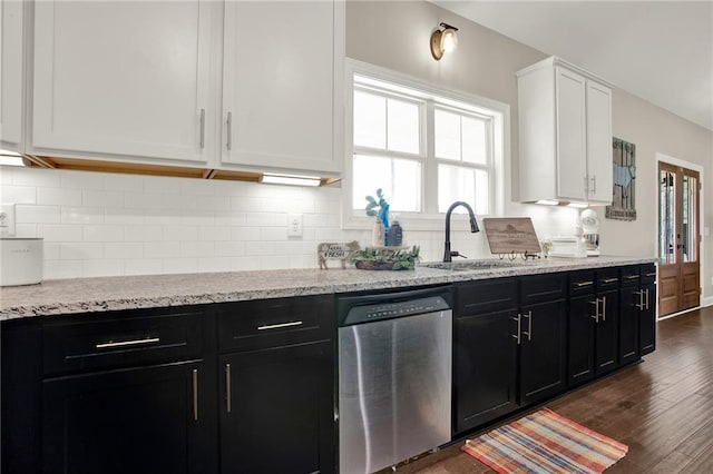 kitchen featuring dark wood-type flooring, sink, stainless steel dishwasher, decorative backsplash, and white cabinets