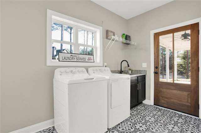 washroom featuring cabinets, plenty of natural light, sink, and washing machine and clothes dryer