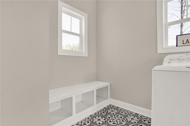 laundry area featuring washer / dryer and tile patterned flooring