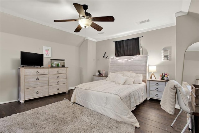 bedroom featuring vaulted ceiling, dark hardwood / wood-style floors, crown molding, and ceiling fan