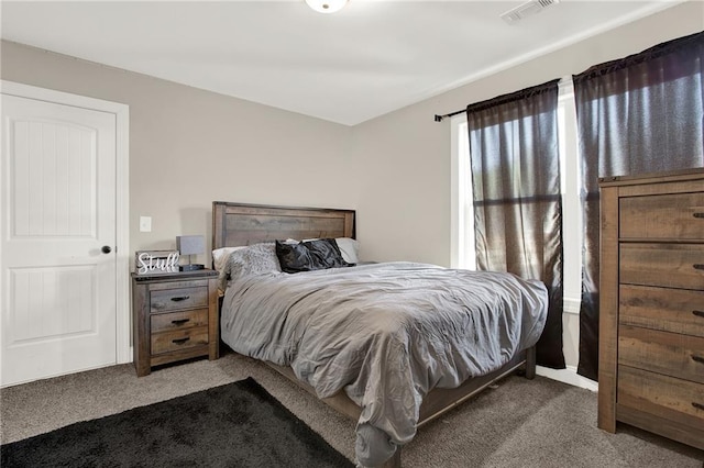 bedroom featuring dark colored carpet