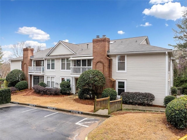 1379 Keys Lake Dr NE, Brookhaven, GA 30319 - back of property featuring a chimney and uncovered parking