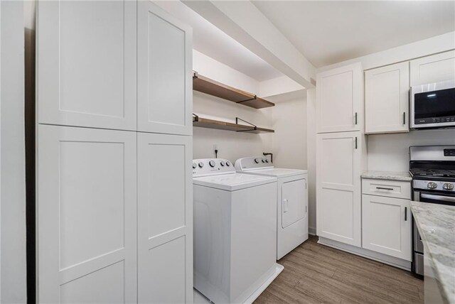 1379 Keys Lake Dr NE, Brookhaven, GA 30319 - laundry room featuring light wood finished floors, laundry area, and washer and dryer