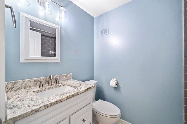 1379 Keys Lake Dr NE, Brookhaven, GA 30319 - bathroom featuring visible vents, toilet, and vanity