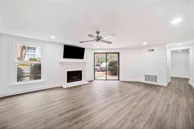 1379 Keys Lake Dr NE, Brookhaven, GA 30319 - unfurnished living room with visible vents, wood finished floors, and a fireplace with raised hearth