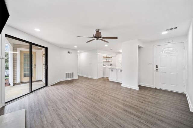 1379 Keys Lake Dr NE, Brookhaven, GA 30319 - unfurnished living room with visible vents, baseboards, and wood finished floors
