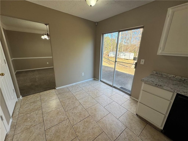 unfurnished dining area with light tile patterned flooring, a chandelier, and a textured ceiling