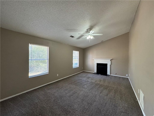 unfurnished living room featuring a textured ceiling, dark carpet, ceiling fan, and lofted ceiling