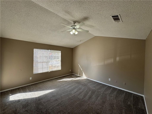 unfurnished room with a textured ceiling, ceiling fan, vaulted ceiling, and dark colored carpet