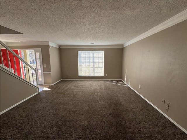 carpeted empty room with crown molding and a textured ceiling