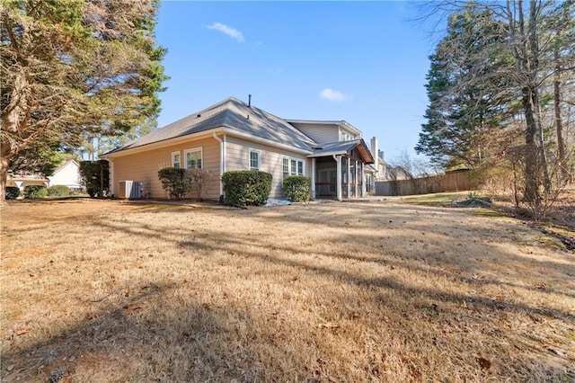 view of side of home featuring a yard and central AC unit