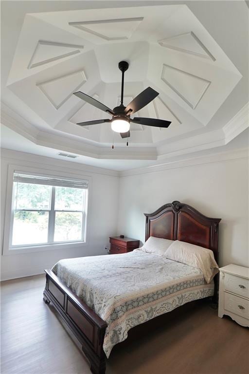 455 Saddle Bow Dr, Lawrenceville, GA 30046 - bedroom featuring a tray ceiling, crown molding, wood finished floors, a ceiling fan, and coffered ceiling