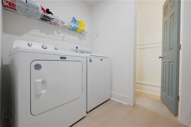 455 Saddle Bow Dr, Lawrenceville, GA 30046 - washroom with washing machine and dryer, light wood-type flooring, and baseboards