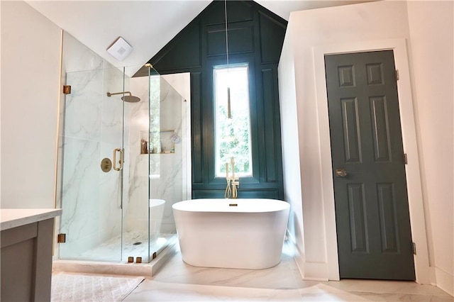 455 Saddle Bow Dr, Lawrenceville, GA 30046 - bathroom featuring a marble finish shower, a freestanding tub, lofted ceiling, and vanity