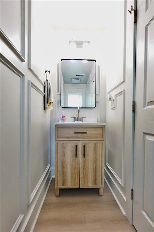 455 Saddle Bow Dr, Lawrenceville, GA 30046 - bathroom with wood finished floors, vanity, and baseboards