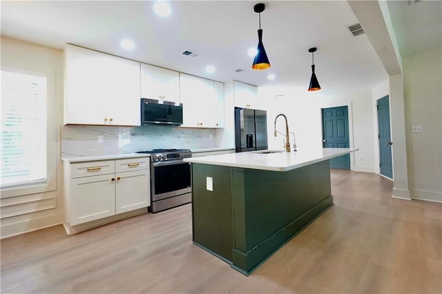 455 Saddle Bow Dr, Lawrenceville, GA 30046 - kitchen featuring appliances with stainless steel finishes, a sink, light wood-type flooring, white cabinets, and recessed lighting