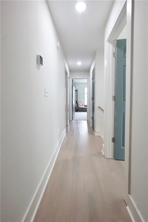 455 Saddle Bow Dr, Lawrenceville, GA 30046 - corridor with baseboards and light wood-style flooring