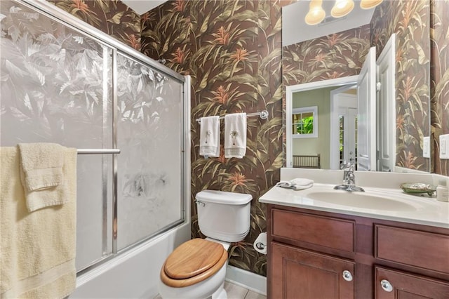 4535 Vanadium Bnd, Cumming, GA 30040 - bathroom featuring wallpapered walls, toilet, vanity, and bath / shower combo with glass door