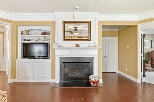 4535 Vanadium Bnd, Cumming, GA 30040 - living area featuring dark wood finished floors, a premium fireplace, ornamental molding, baseboards, and built in shelves