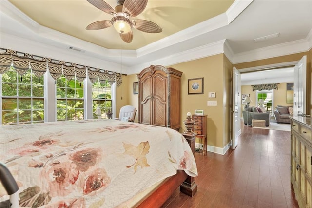 4535 Vanadium Bnd, Cumming, GA 30040 - bedroom featuring multiple windows, a tray ceiling, ornamental molding, dark wood-type flooring, and baseboards