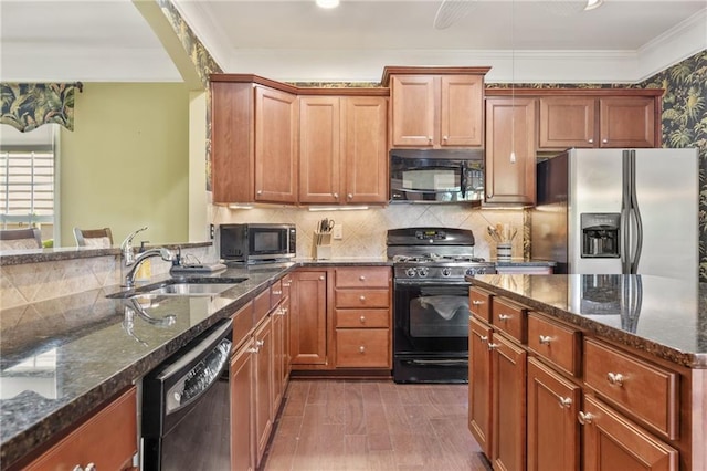 4535 Vanadium Bnd, Cumming, GA 30040 - kitchen with black appliances, a sink, dark stone countertops, crown molding, and dark wood finished floors