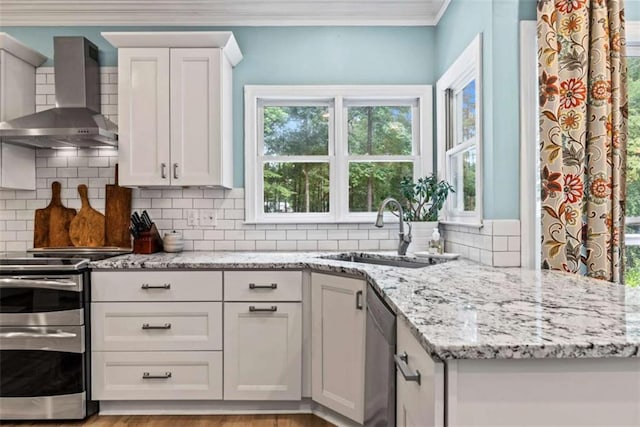 25 Highlands Way, Oxford, GA 30054 - kitchen with wall chimney exhaust hood, a sink, appliances with stainless steel finishes, ornamental molding, and white cabinetry