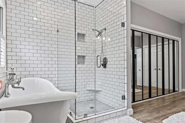 25 Highlands Way, Oxford, GA 30054 - full bathroom with a stall shower, wood finished floors, and a soaking tub