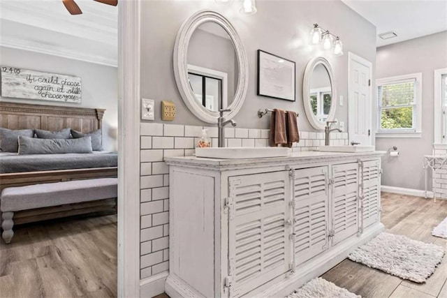 25 Highlands Way, Oxford, GA 30054 - bathroom with double vanity, wood finished floors, connected bathroom, a ceiling fan, and crown molding