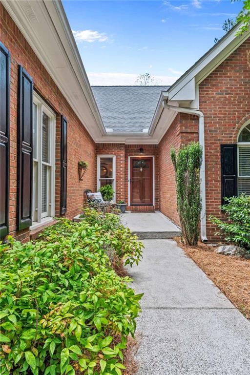 25 Highlands Way, Oxford, GA 30054 - doorway to property featuring brick siding and a shingled roof