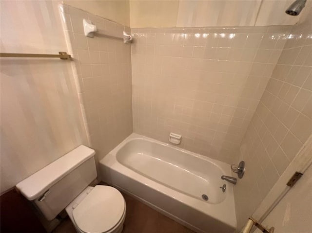 bathroom with bathtub / shower combination and toilet