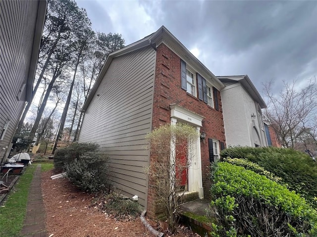 view of side of home featuring brick siding