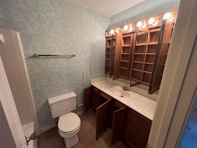 bathroom with toilet, a textured ceiling, and vanity