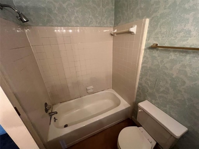 full bathroom with toilet, wallpapered walls, and shower / bathing tub combination