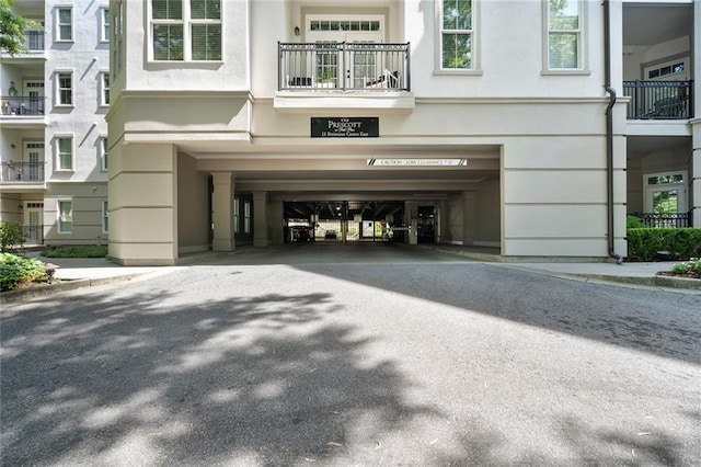 doorway to property featuring a carport and driveway