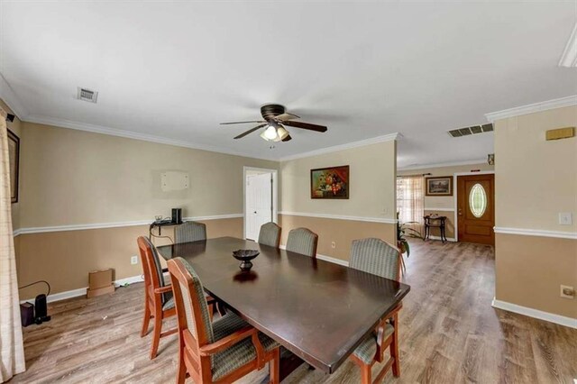 1131 Planing Mill Rd, Greensboro, GA 30642 - dining space with a ceiling fan, light wood-style flooring, baseboards, and crown molding